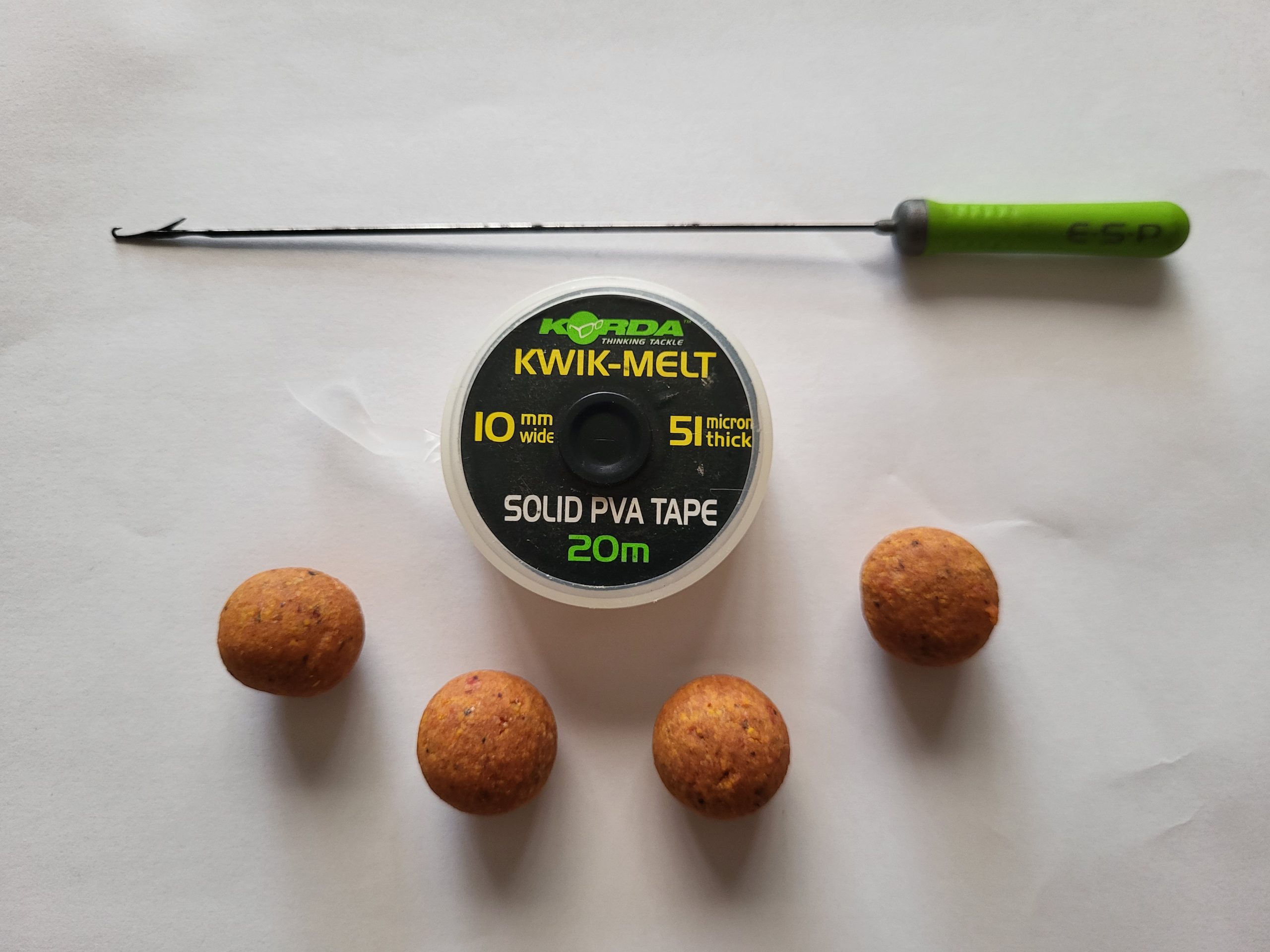 PVA stringer baiting needle, PVA tape and boilies ready for making a carp fishing stringer